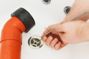 Drain snake being use in bathroom sink drain